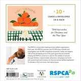 RSPCA Christmas card pack insert showing a festive illustration of oranges on a tree, text stating '10 CARDS & ENVELOMES IN A PACK,' a small dog photo, product details, barcode, and RSPCA and Vevoke logos.