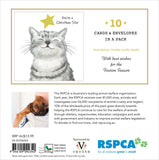 Back of a Christmas card pack insert showing a white cat illustration, text stating 'You're a Star' and '10 Cards & Envelopes in a Pack,' plus a small photo of a dog holding a card, product details, barcode, and sponsor logos including RSPCA and Vevoke.