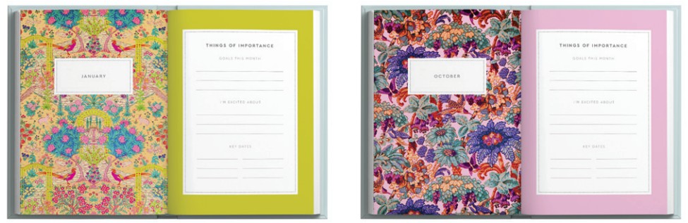 Two colorful notebooks with floral designs on the cover and pink and green spines.