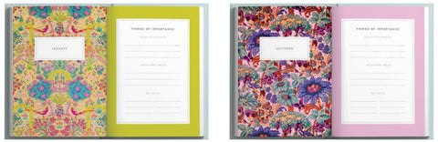 Two colorful notebooks with floral designs on the cover and pink and green spines.