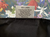 Fabric tag with care instructions on a floral background