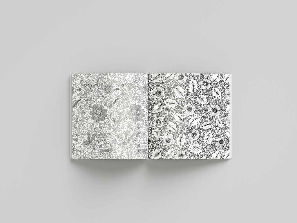 Open book displaying black and white floral patterns on a gray background