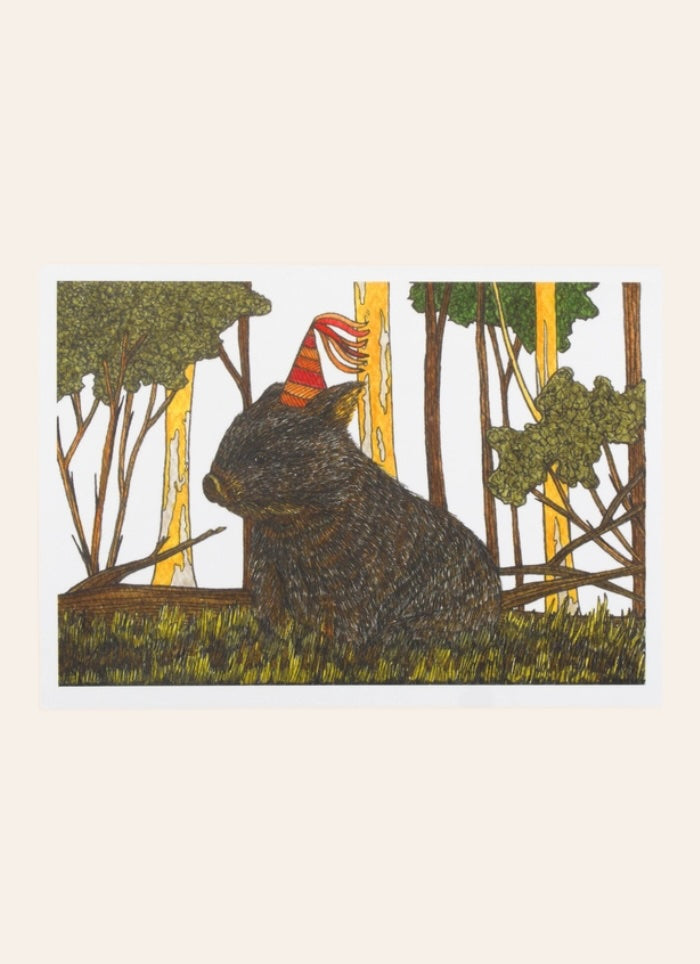 Wombat in trees on grass