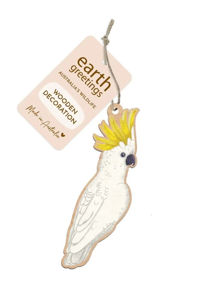Wooden cockatoo decoration with 'earth greetings' tag on a white background