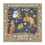 A square package of Earth Greetings Christmas cards featuring a festive illustrated design with a koala, kangaroo, bird, gifts, trees, and flowers on a dark blue background, surrounded by a tan border with white snowflake motifs and the text '8 CHRISTMAS CARDS' and 'earth greetings'.