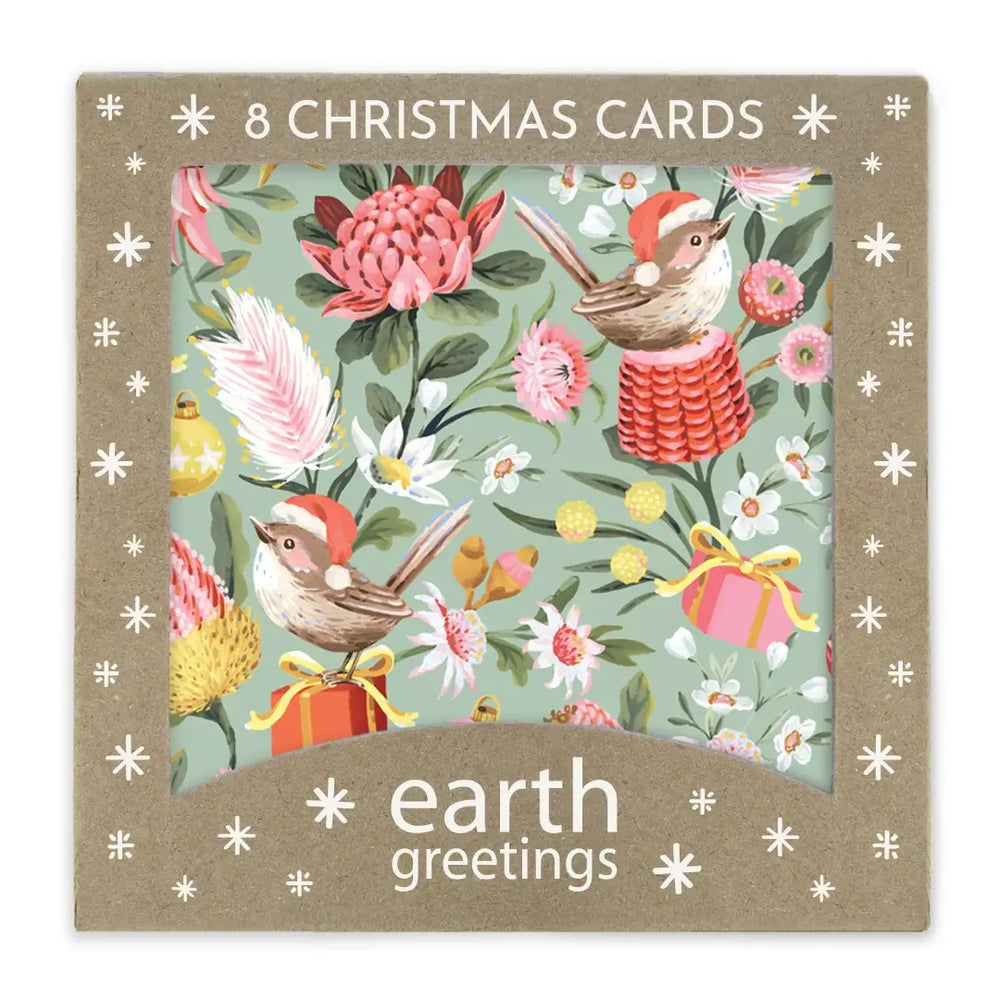 A boxed set of 8 Christmas greeting cards from earth greetings, featuring a festive illustration of small birds in Santa hats among pink flowers, green leaves, and gift boxes on a kraft paper package.