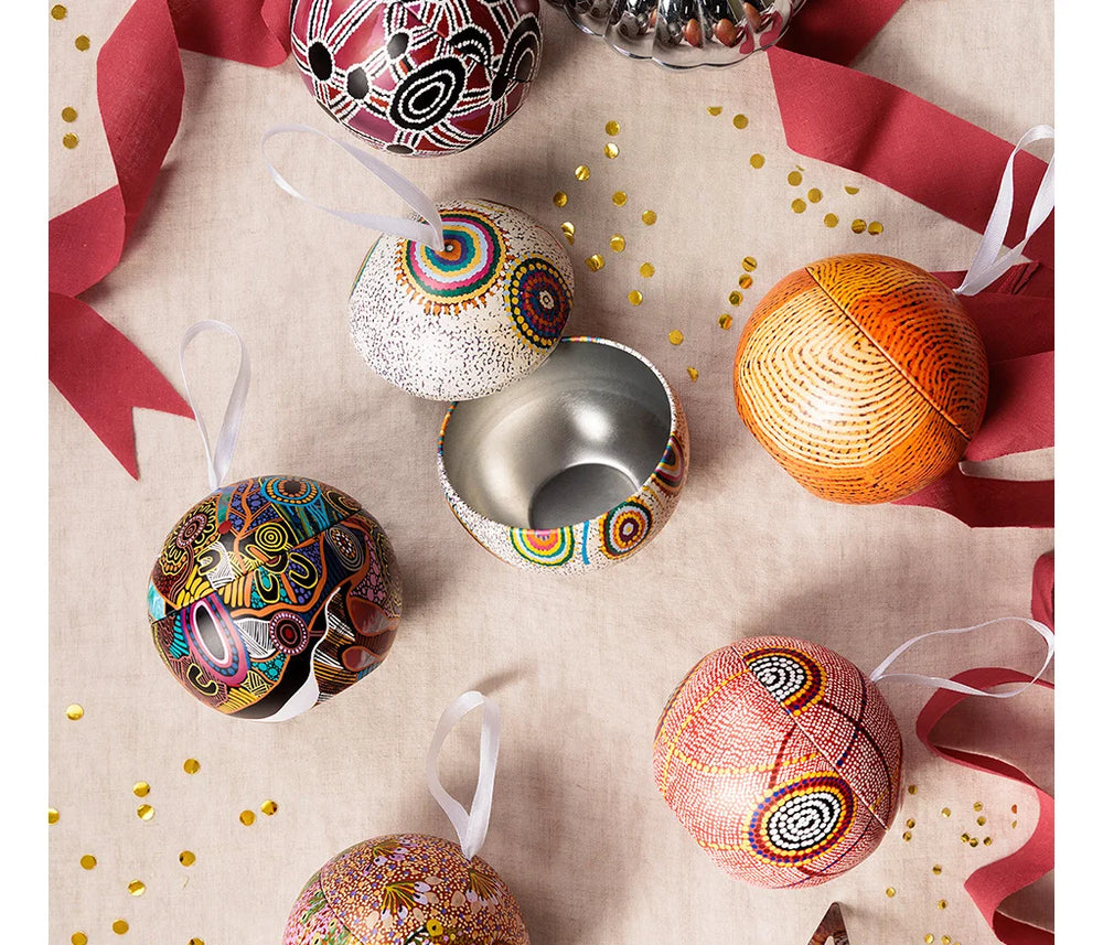 Several balls, one is open on a table with ribbon.