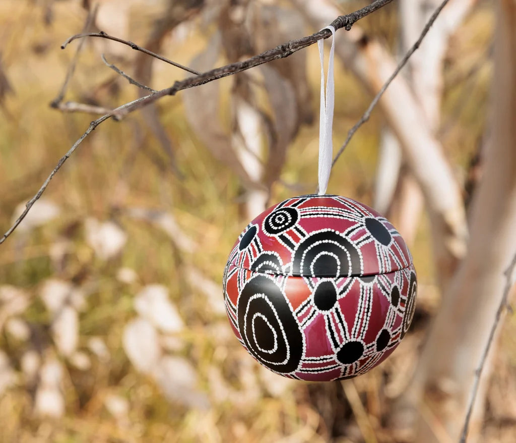 Bess Napanangka Christmas bauble hanging outside on a tree in the Australian bush