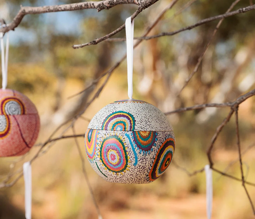A Christmas ball hanging in a tree outside in the Australian bush