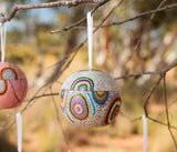 A Christmas ball hanging in a tree outside in the Australian bush