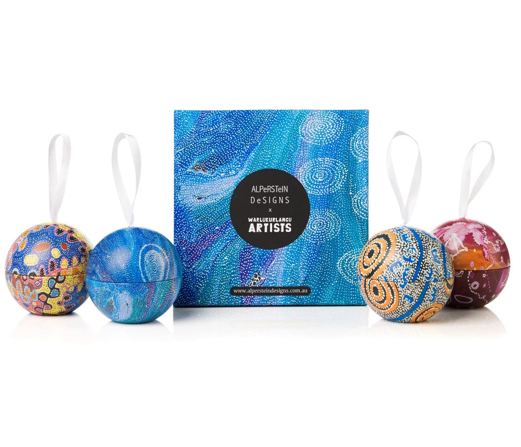 A blue box and 4 Christmas decorations with ribbons attached.