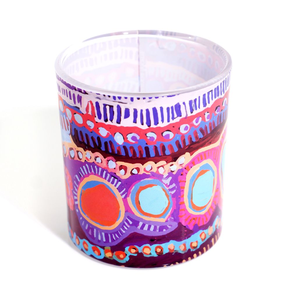 Colorful patterned glass container on a white background