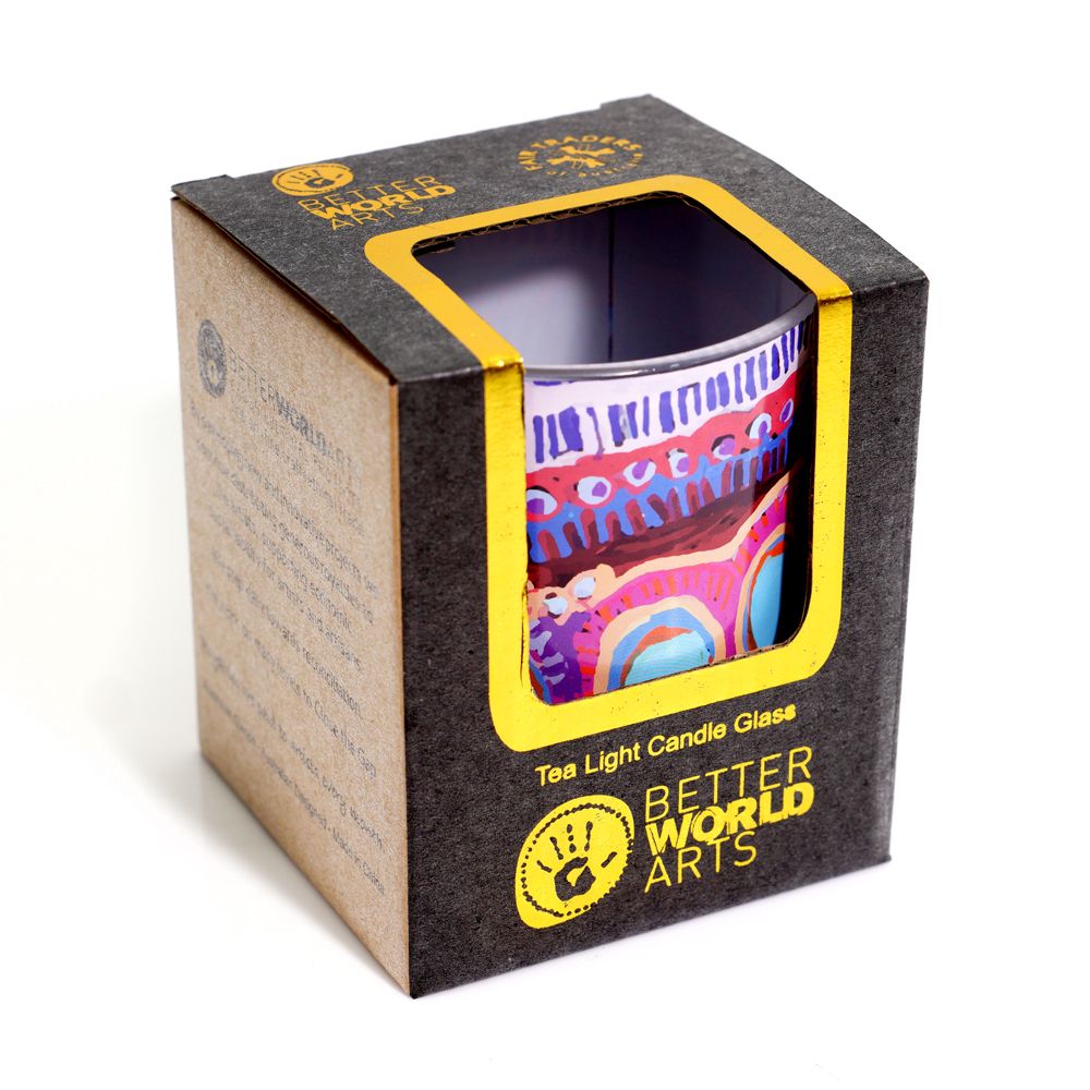 Colorful tea light candle glass in a Better World Arts box on a white background
