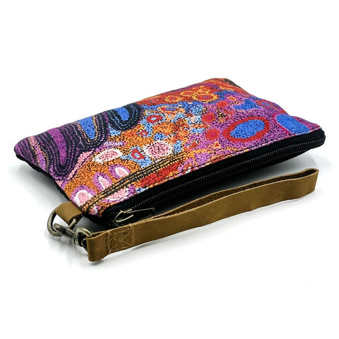 Colorful clutch with a brown strap on a white background