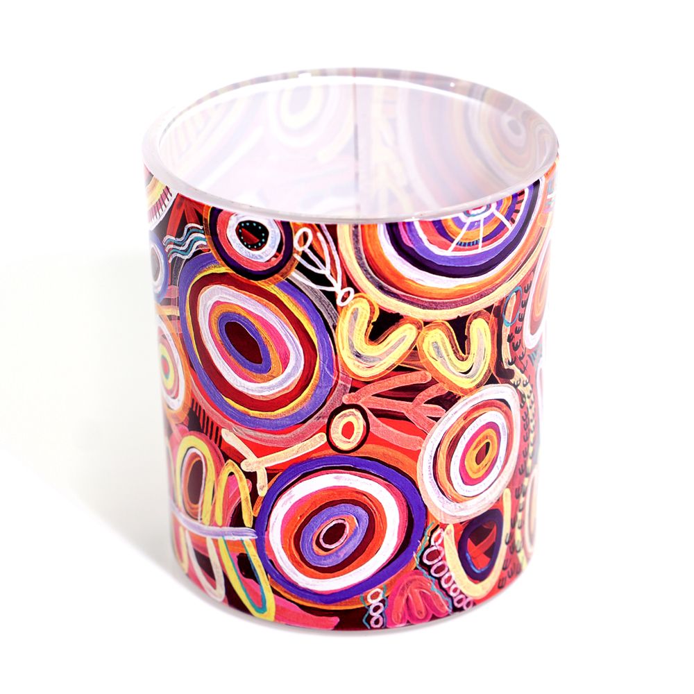 Colorful circular patterned candle on a white background