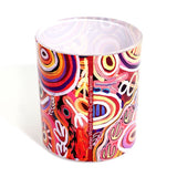 Colorful cylindrical container with abstract design on a white background