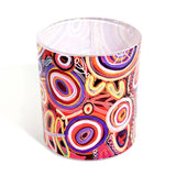 Colorful circular patterned candle on a white background