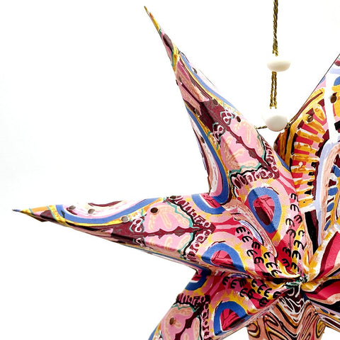 Colorful butterfly-shaped ornament with intricate patterns on a white background