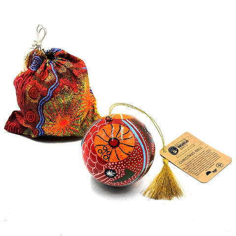 Decorative Christmas ball with tassel and colorful drawstring bag on a white background
