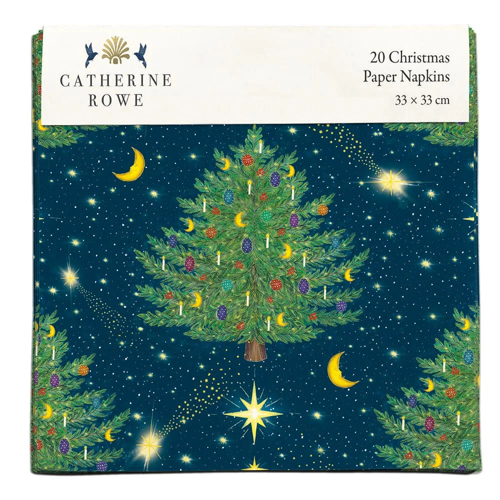 A pack of paper napkins with a green tree with decorations on a dark blue background with stars and moons.