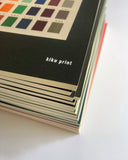 Stack of books with 'kiku print' branding on a white background