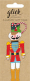 A nutcracker figure in a pack of  gift tags by Glock