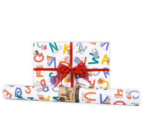 Gift wrap with colorful alphabet design and a red ribbon on a white background
