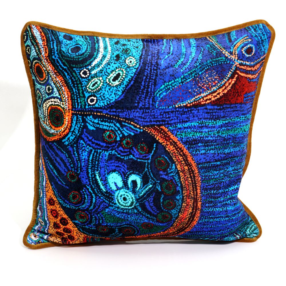 Decorative pillow with intricate blue and orange patterns on a white background