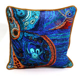 Decorative pillow with intricate blue and orange patterns on a white background