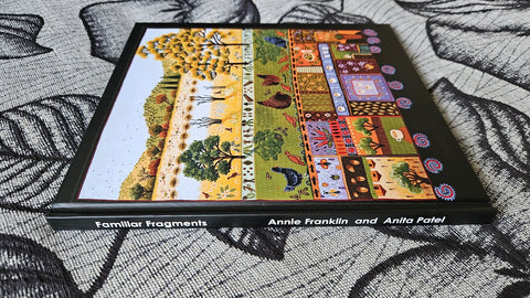 Book titled 'Familiar Fragments' by Annie Franklin and Anila Patel on a textured surface