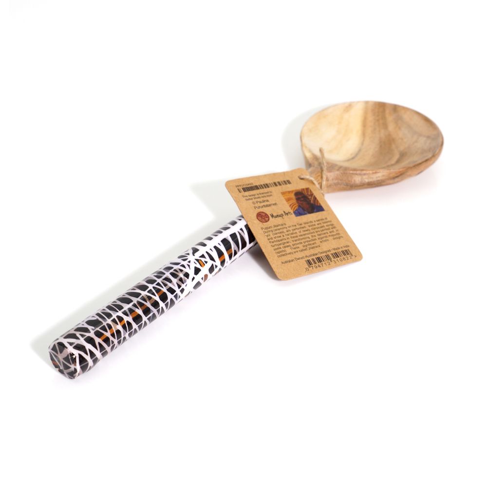 Roll of paper with a pattern, wooden spoon, and card on a white background