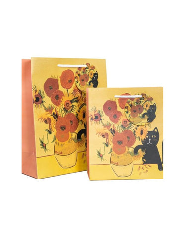 A yellow gift bag showing a black cat destroying a vase of sunflowers on a table.