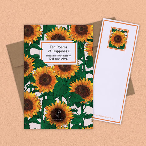 Book cover with sunflower design and a matching notepad on a beige background