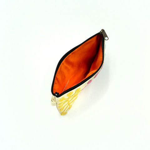 Pouch with orange interior and floral pattern on a white background