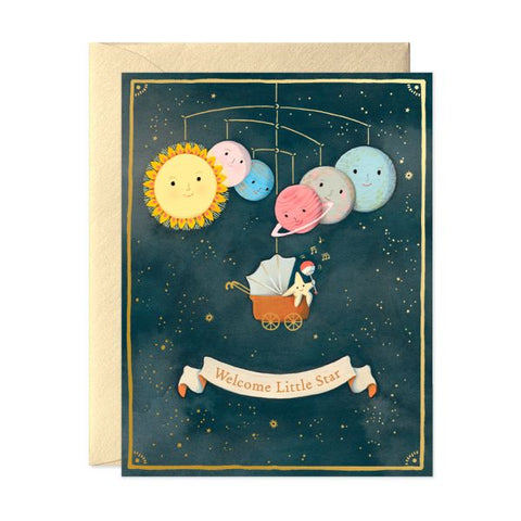 Greeting card with space-themed illustration of planets and sun, featuring a baby in a stroller under a banner that says 'Welcome Little Star'.